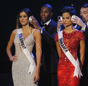 Vega, Fennell, and Harkusha are seen with headphones during a question phase of the 63rd Annual Miss Universe Pageant in Miami